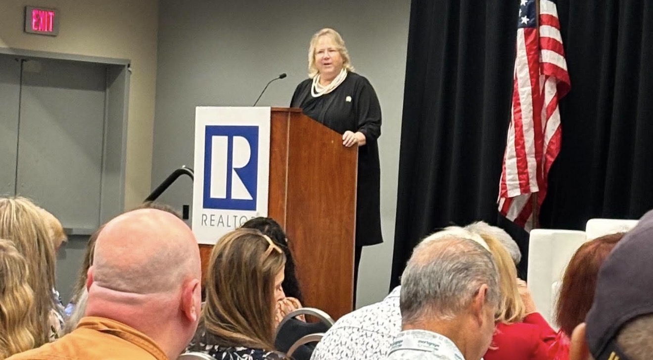 Standing-room crowd at NAR Regulatory Issues Forum AI regulation session with Cyndee Haydon 2026 Forum Chair at Realtor-branded podium REALTORS Legislative Meetings Washington DC June 15 2026